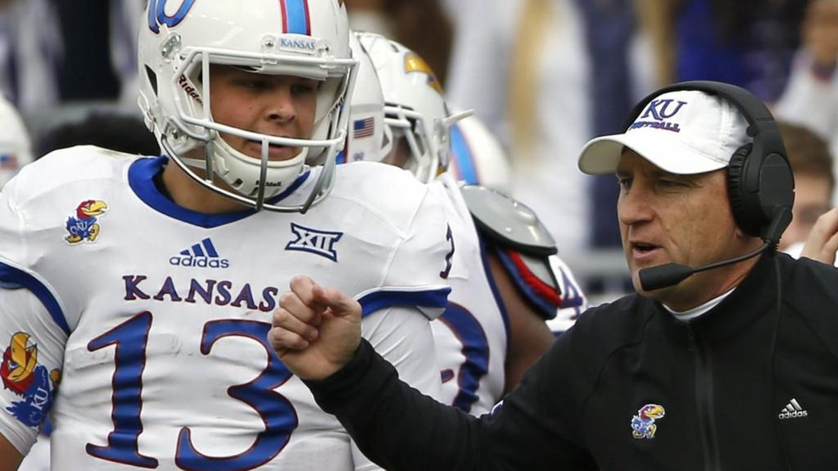 Kansas coach David Beaty and quarterback Ryan Willis (13) work from the sidelines against TCU in the first half of an NCAA college football game Saturday, Nov. 14, 2015, in Fort Worth, Texas. (AP Photo/Ron Jenkins)