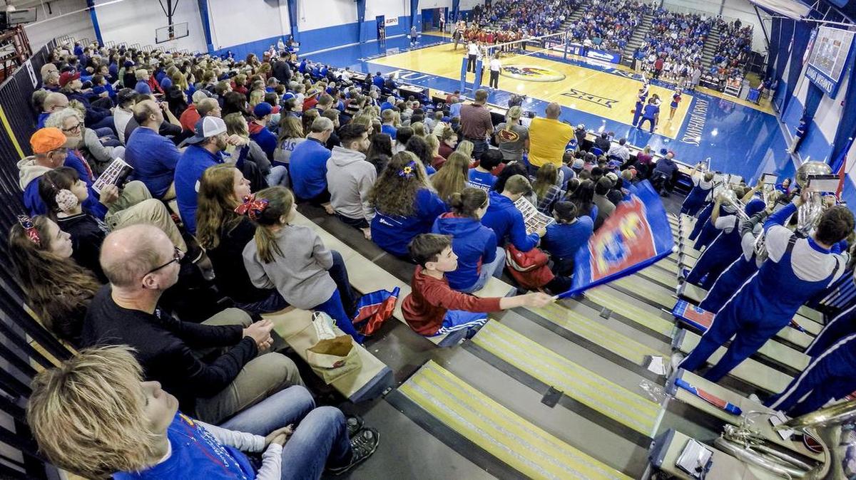 A sold-out Horejsi Family Athletics Center cheered for the Kansas Jayhawks women’s volleyball team during a Big 12 match against Iowa State in Lawrence. The team is playing for a repeat trip to the NCAA’s Final Four, drawing a dedicated and rowdy fanbase to the gym next to Allen Fieldhouse.