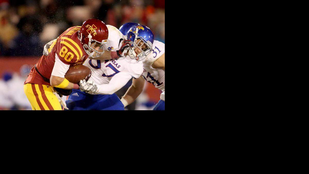 
Iowa State wide receiver Justin Coleman (80) tries to fight off a tackle by Kansas linebacker Jake Love last season in Lawrence.
