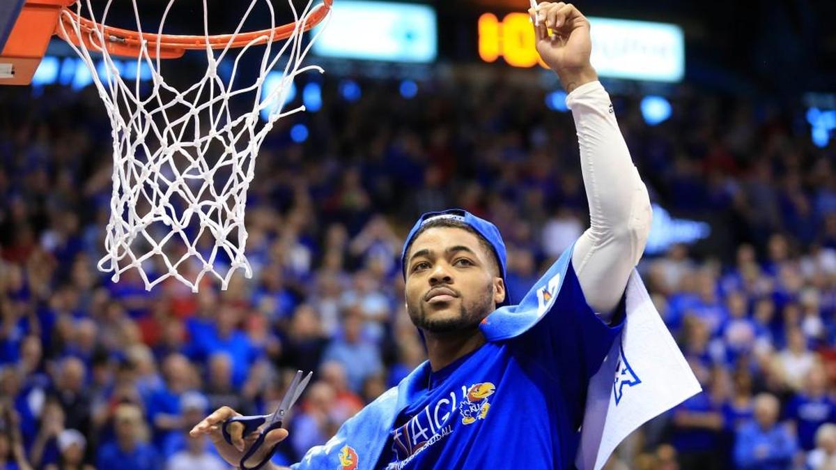 Kansas guard Frank Mason cuts down the net following Saturday’s win over Texas Tech.