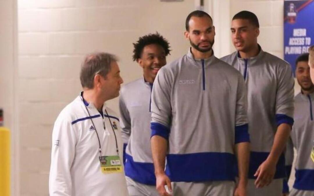 The Kansas starting five make their way to interview rooms in the KFC Yum Center on Friday. The Jayhawks will play Villanova for a spot in the Final Four on Saturday.