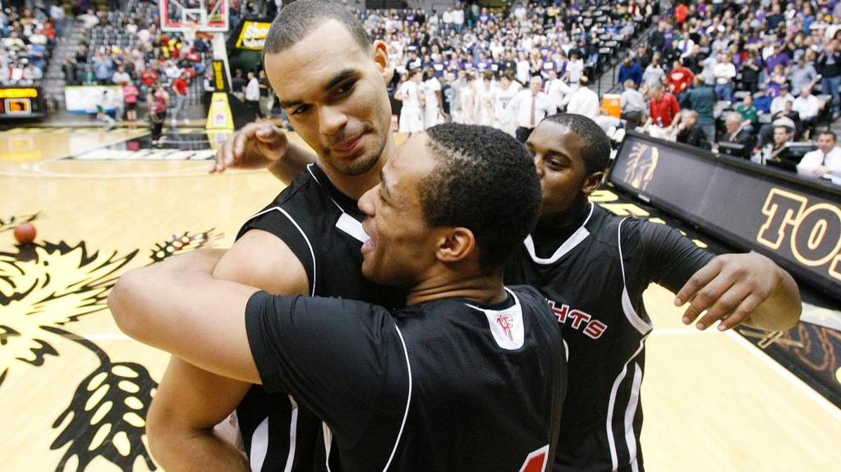 Ellis is hugged by teammate Chris Reed (14) and Gabe Lynch after the 2012 Class 6A championship, the Falcons’ fourth with Ellis in uniform.