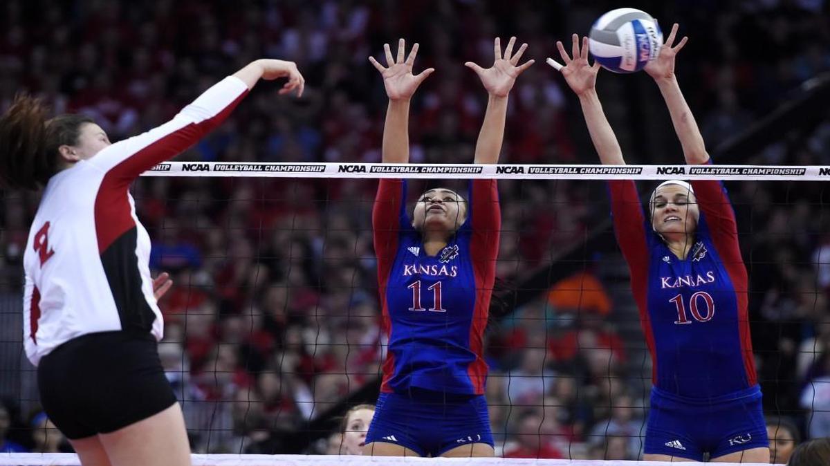 KU's Ainise Havili (11) and Taylor Soucie tried to block a spike by Nebraska's Mikaela Foecke during Thursday’s NCAA volleball semifinal match in Omaha.