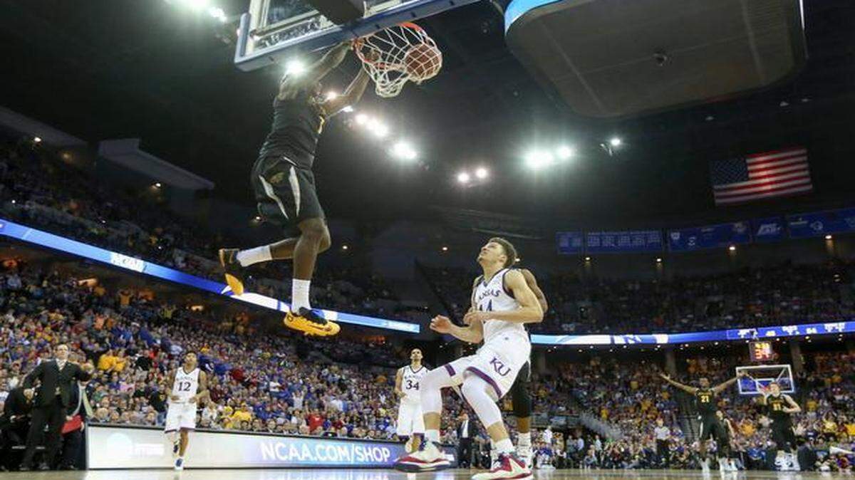 
Wichita State's Zach Brown dunks during the second half Sunday against Kansas.
