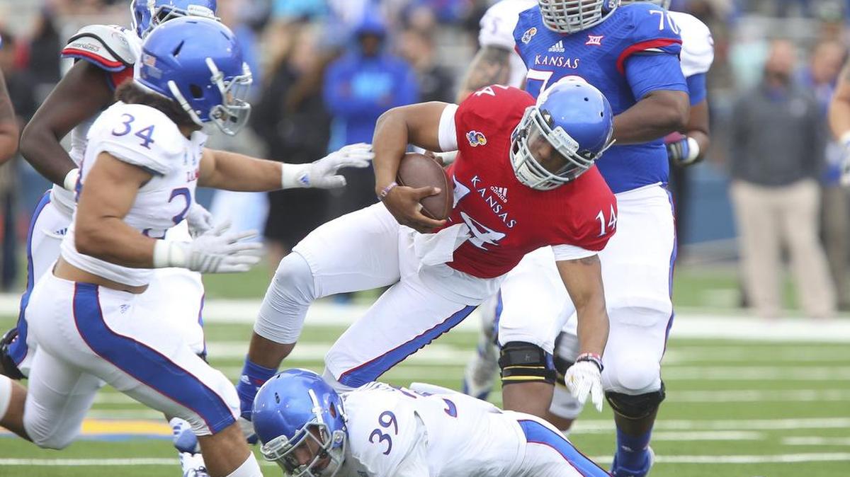 
Quarterback Michael Cummings is tackled by safety Michael Glatczak during Kansas’ spring game April 25. Cummings was injured on the play and could miss the entire 2015 season.
