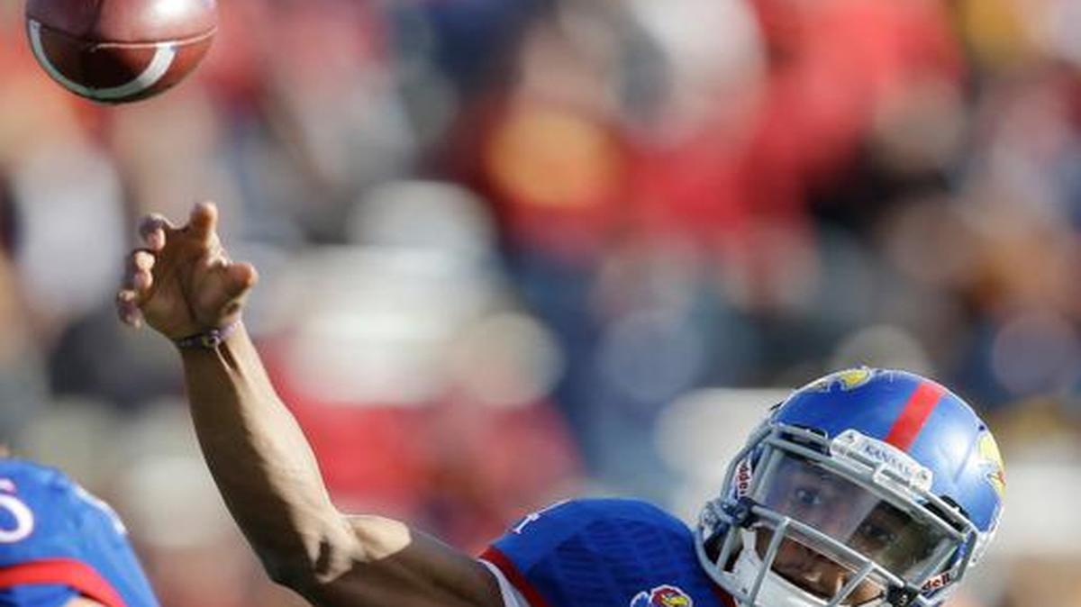 
Kansas quarterback Michael Cummings passes to a teammate during the first half against Iowa State on Saturday in Lawrence.

