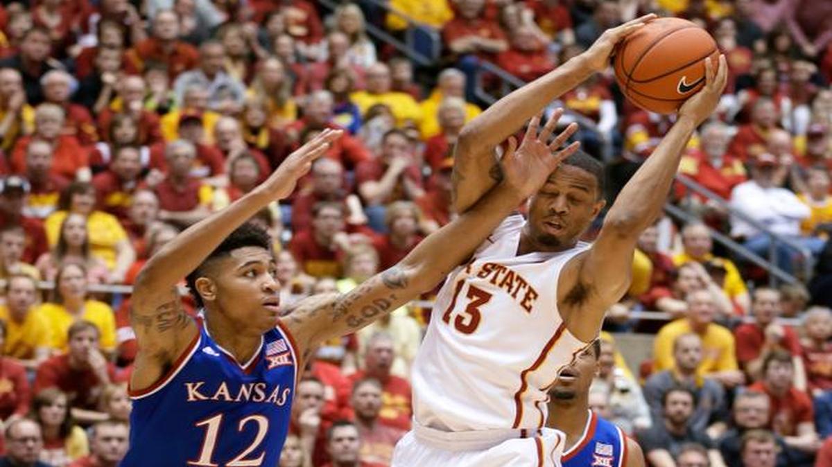 
Iowa State guard Bryce Dejean-Jones grabs a rebound next to Kansas guard Kelly Oubre Jr. during the first half Saturday in Ames, Iowa.
