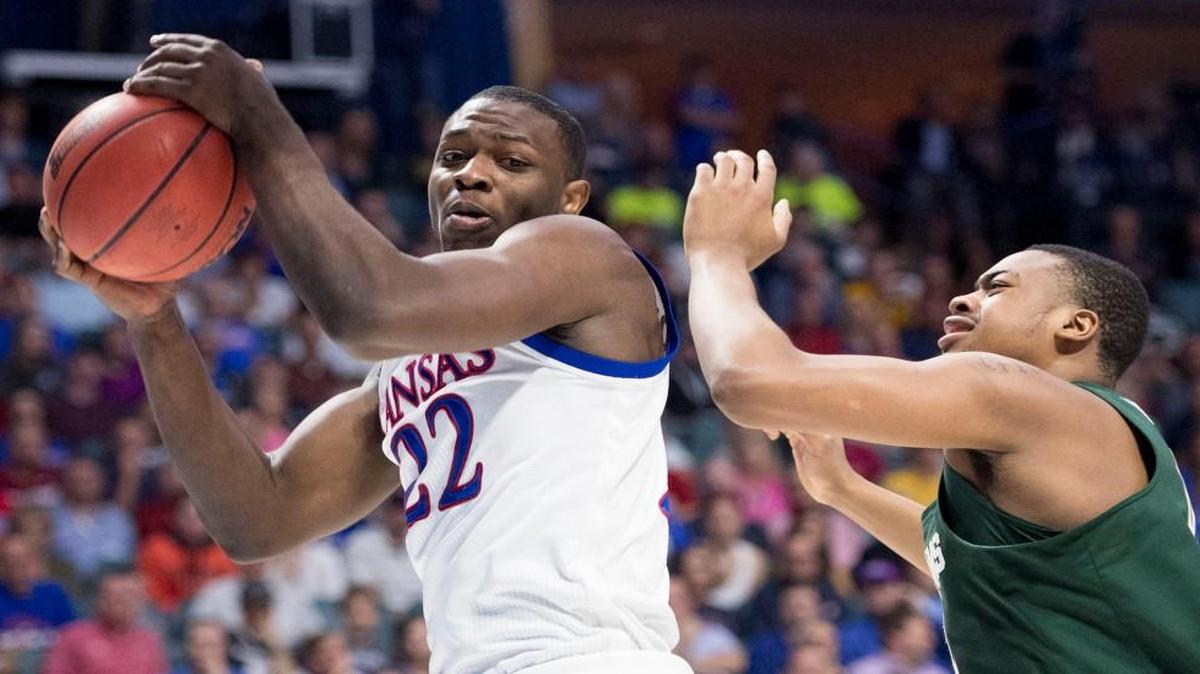 Kansas forward Dwight Coleby grabs a rebound in front of Michigan State forward Nick Ward in the second half of Sunday’s NCAA Tournament second-round game in Tulsa.