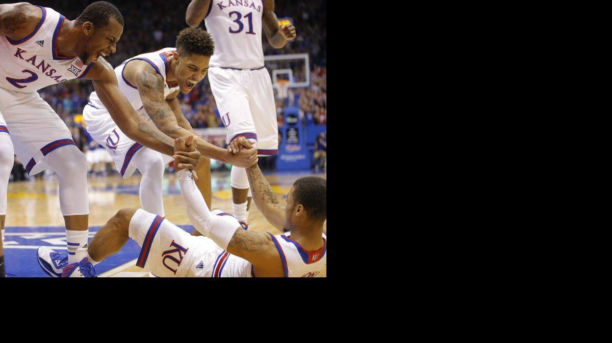 
Kansas guard Frank Mason is picked up by teammates Cliff Alexander, left, and Kelly Oubre Jr. after he made a shot during the first half Tuesday night at Allen Fieldhouse.
