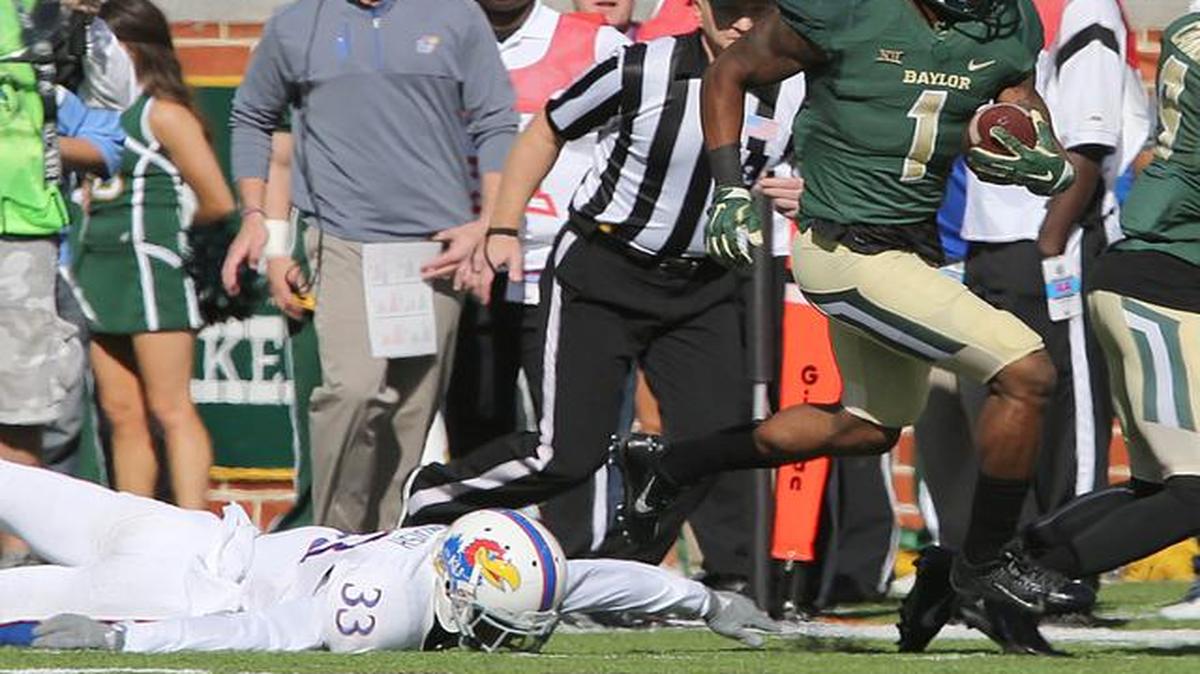 
Corey Coleman runs past Kansas safety Cassius Sendish for a touchdown in the first half Saturday in Waco, Texas. 
