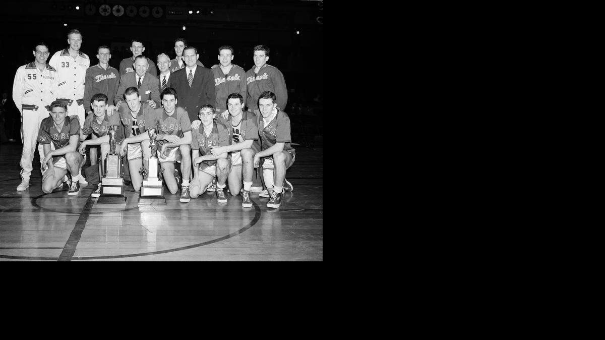 
Members of the U.S. Olympic basketball team pose with the team's coaches in New York's Madison Square Garden, April 1, 1952, after Peoria Caterpillars defeated Kansas, 62-60, in the Olympic tournament final. Front row from left: Bob Kenney, John Keller, Clyde Lovellette, Bill Lienhard, Dean Kelley, Charlie Hoag and Bill Hougland, all of Kansas. Center row from left: coach Forrest C. "Phog" Allen, who will be assistant coach of the Olympic team; Howard Hobson of Yale, chairman of the Olympic committee; and Peoria Coach Warren Womble, who will be head coach of the Olympic team. Back row, from left: Wayne Glasgow and Bob Kurland of Phillips Oilers, Ron Bontemps, Frank McCabe, Marcus Freiberger, Dan Pippin and Howie Williams, all of Peoria. 

