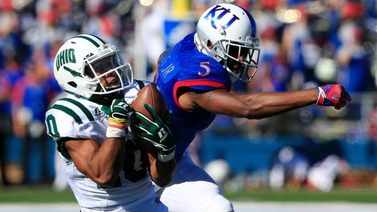 Ohio cornerback Randy Stites intercepts a pass in front of Kansas’ Bobby Hartzog on Saturday in Lawrence.