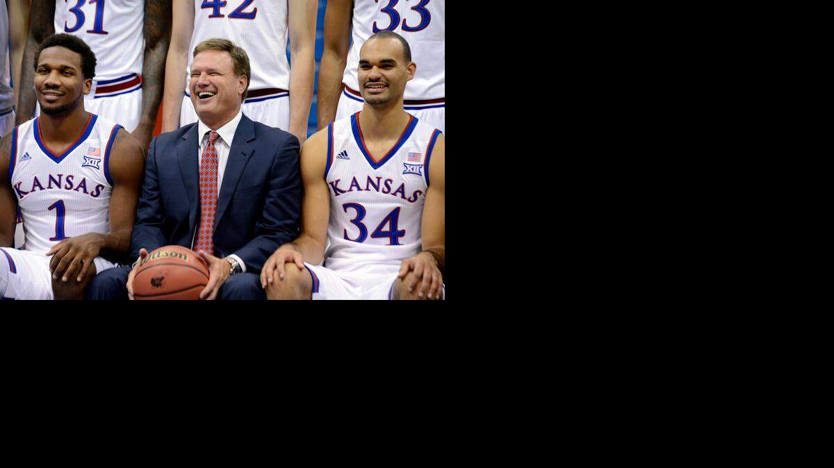 
KU coach Bill Self sits between Wayne Selden Jr., left, and Perry Ellis duting the team picture photo session Thursday in Lawrence. 
