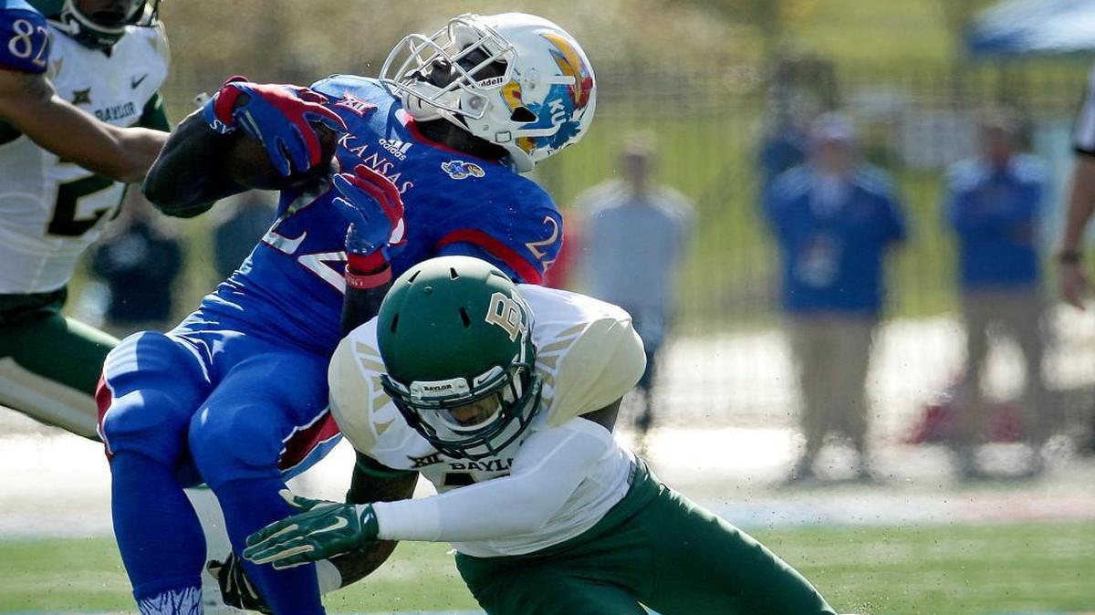 
Kansas running back Ke’aun Kinner is tackled by Baylor safety Chance Waz during the first half Saturday in Lawrence
