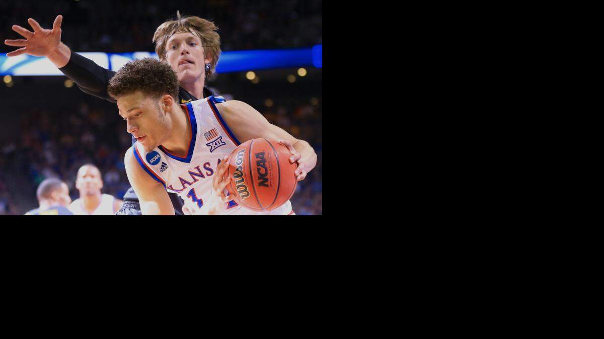 
Kansas' Brannen Greene, front, is guarded by Wichita State's Ron Baker during their March 22 game in Omaha.
