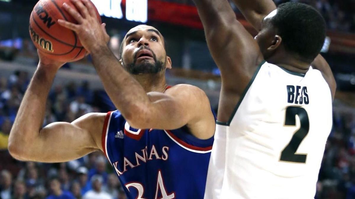 Kansas forward Perry Ellis, left, looks to the basket as Michigan State forward Javon Bess defends during the first half Tuesday in Chicago.