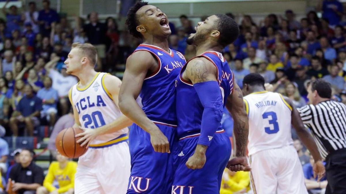 Kansas' Frank Mason III, right, celebrates with Devonte' Graham left, after scoring, as UCLA's Bryce Alford (20) and Aaron Holiday (3) walk away during the first half of the Maui Invitational on Tuesday in Lahaina, Hawaii.