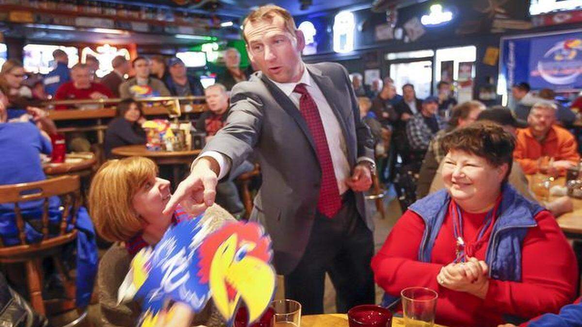
Kansas football coach David Beaty greets KU fans during a stop at Larry Bud’s on Thursday.
