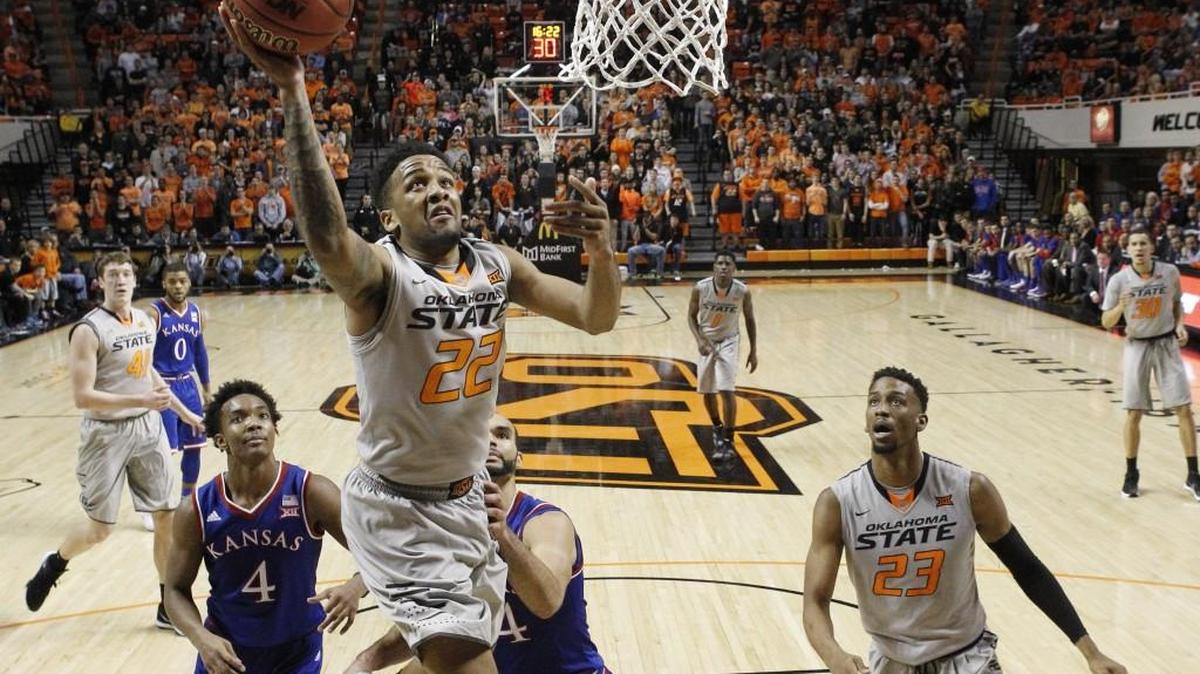 Oklahoma State guard Jeff Newberry took a shot in front of Kansas guard Devonte’ Graham (left), forward Perry Ellis and Cowboys teammate guard Leyton Hammonds during a game last month in Stillwater, Okla. Oklahoma State won 86-67.
