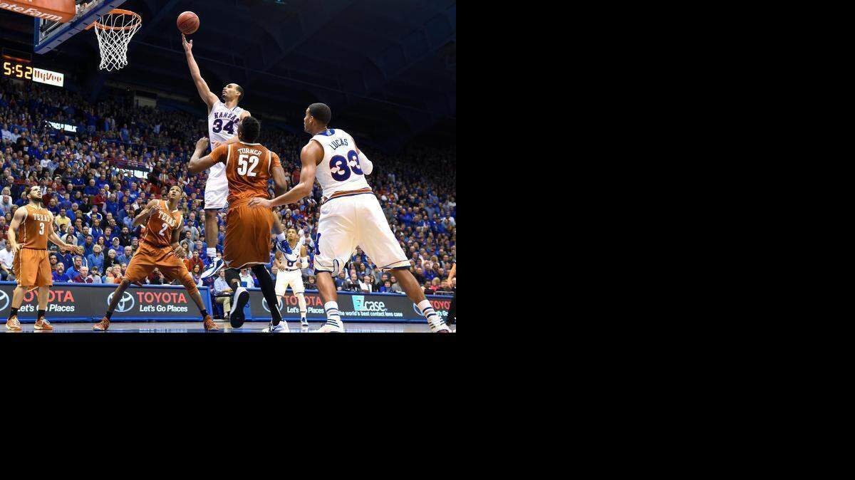 
KU's Perry Ellis rose above the crowd and poured in a game-high 28 points in the Jayhawks 69-64 win Saturday over Texas at Allen Fieldhouse. He split Texas defenders Demarcus Holland (2) and Myles Turner on this drive down the lane during the first half.
