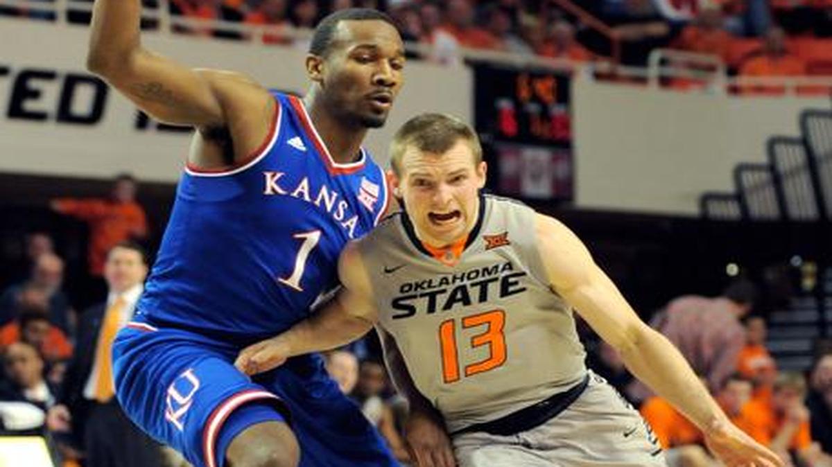 
Oklahoma State guard Phil Forte drives past Kansas guard Wayne Selden Jr. during the first half Saturday in Stillwater, Okla.
