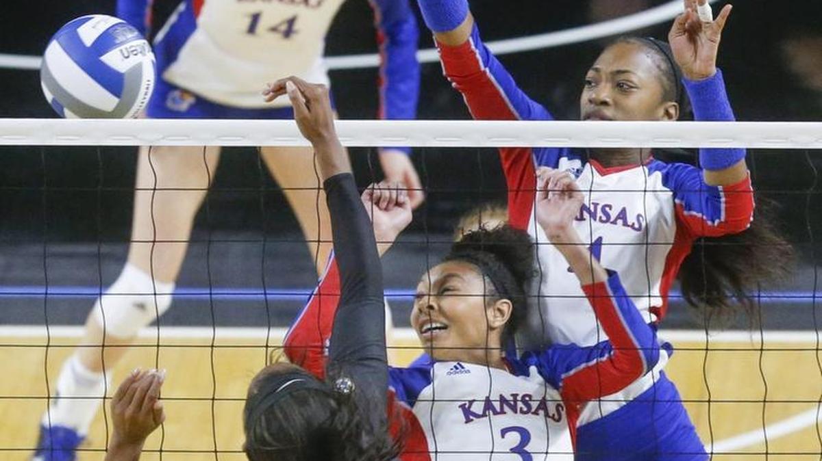 Kansas' Kayla Cheadle (3) and Jada Burse, right, react as Missouri's Alyssa Munlyn (8) spikes the ball during their match Friday night at Koch Arena.