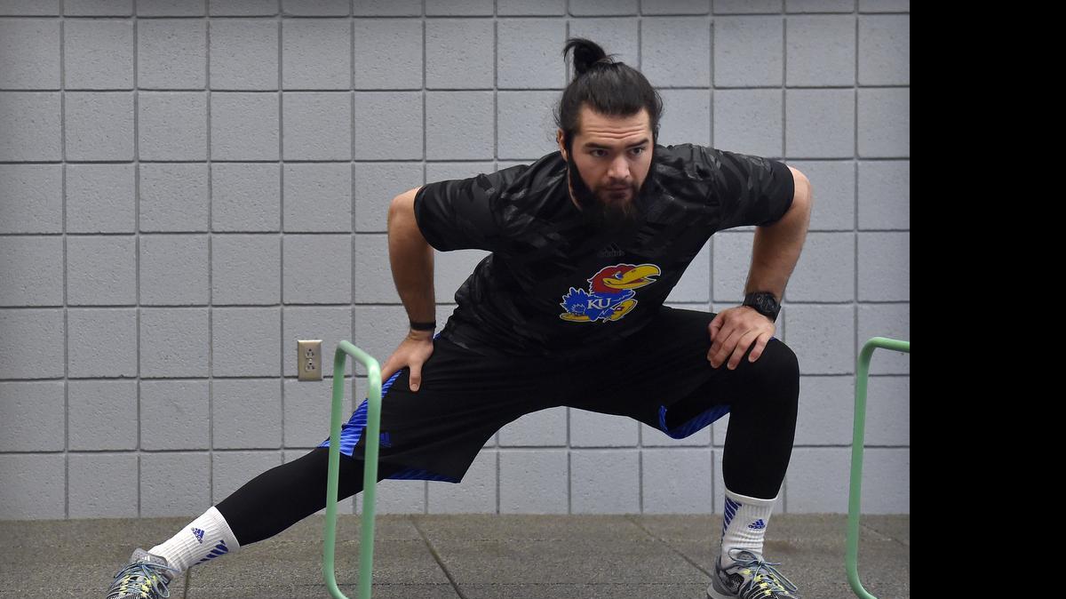 
Ben Heeney, a former linebacker on the Kansas football team, stretches during a recent pre-draft workout at KU.
