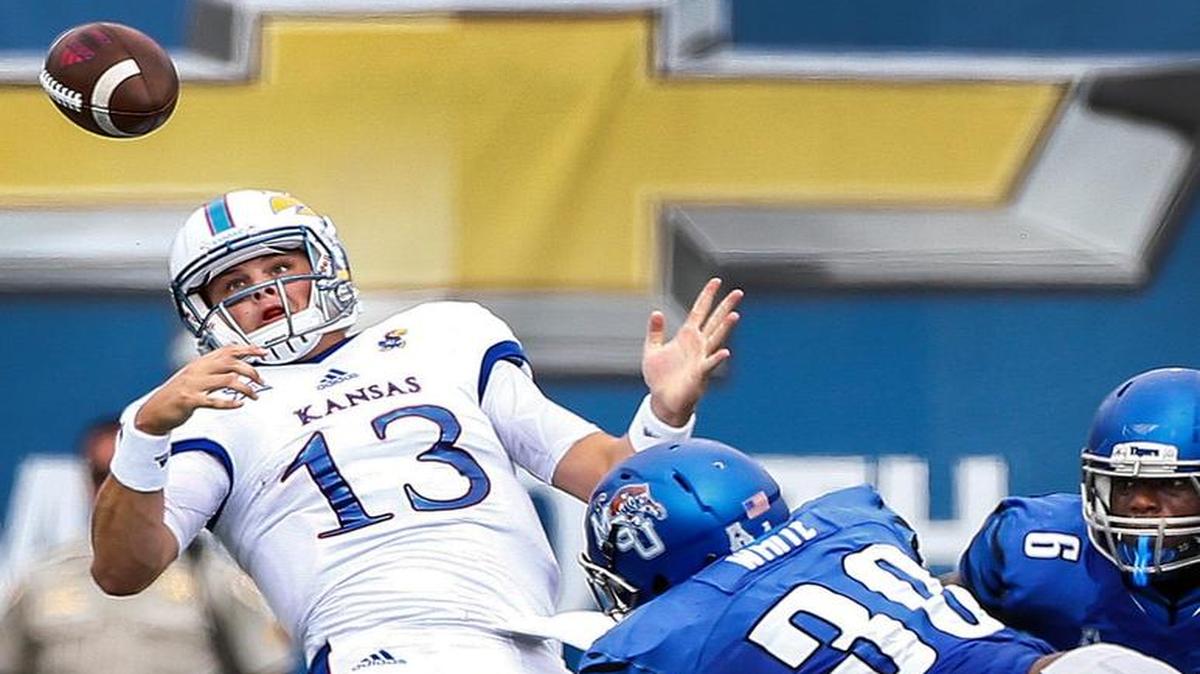Memphis defender Shareef White, right, knocks the ball away from Kansas quarterback Ryan Willis on Sept. 17 in Memphis.