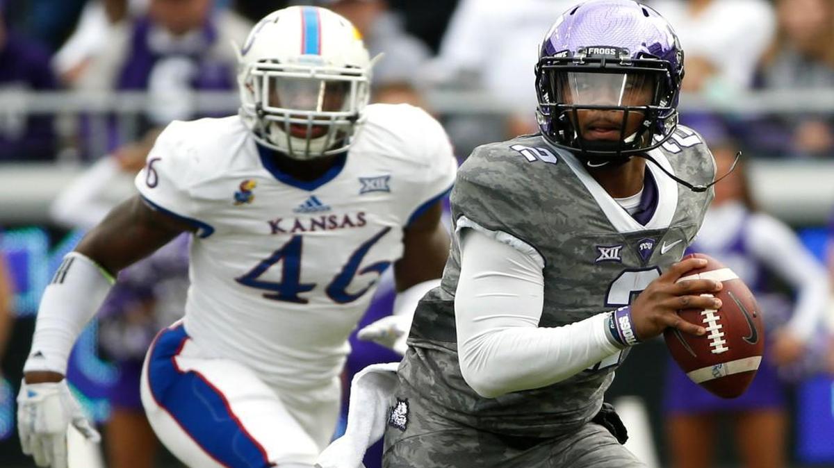 TCU quarterback Trevone Boykin eludes Kansas defensive end Dorance Armstrong Jr. in the first quarter Saturday in Fort Worth. Boykin missed the second half with an injury.