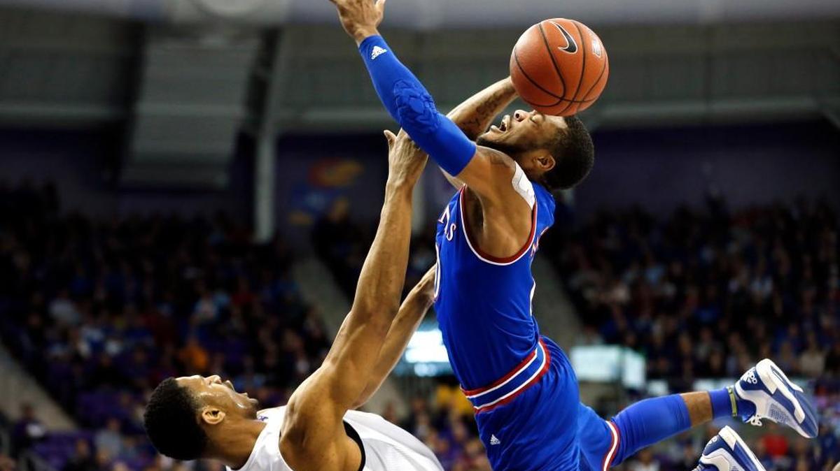 TCU forward Karviar Shepherd, left, and Kansas guard Frank Mason III, right, collide during the first half of an NCAA college basketball game, Saturday, Feb. 6, 2016, in Fort Worth.