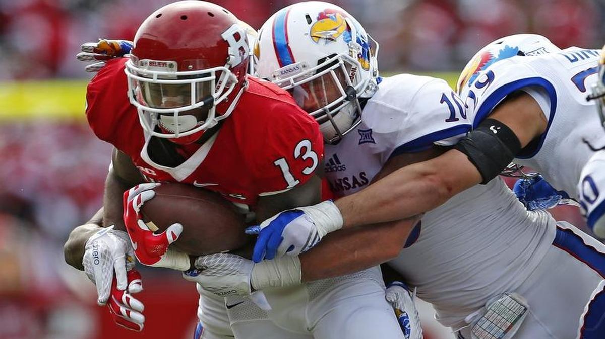 Kansas’ Ben Goodman and Joe Dineen tackle Rutgers wide receiver Carlton Agudosi in September. The Jayhawks held Rutgers to 27 points that day, the fewest points KU has allowed this season.