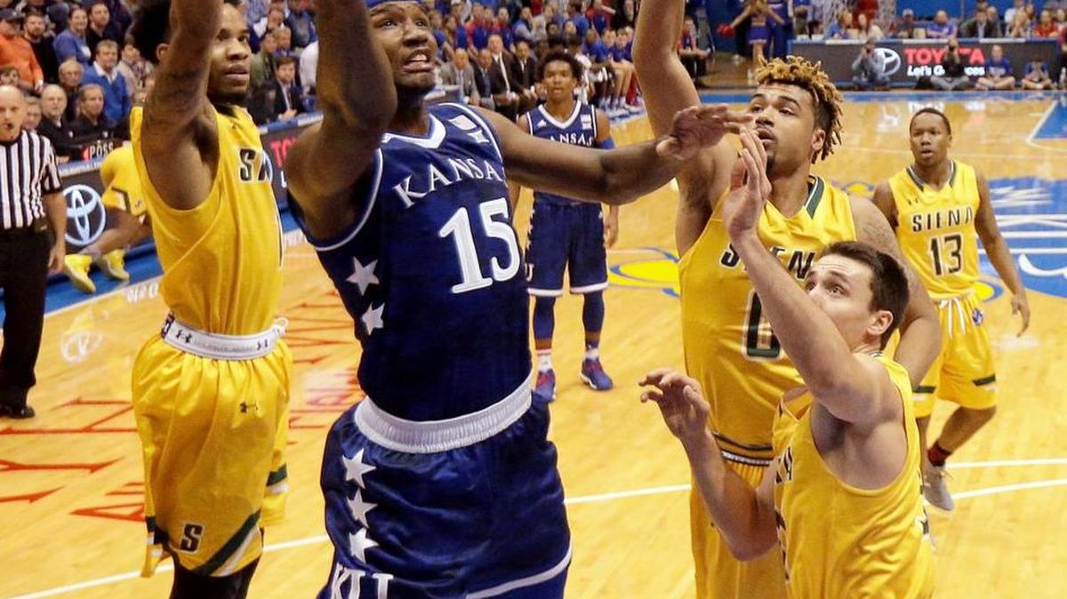 Kansas' Carlton Bragg Jr. gets past a group of Siena defenders to put up a shot during the first half Friday in Lawrence.