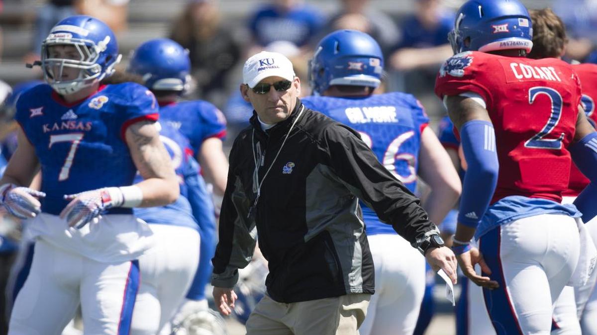 Kansas football coach David Beaty (center) still hasn’t decided whether Montell Cozart (right) or Ryan Willis will be the starting quarterback this season.
