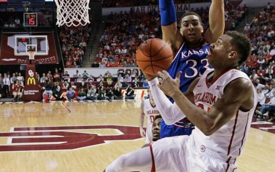 
Oklahoma guard Buddy Hield shoots in front of Kansas forward Landen Lucas in the first half Saturday in Norman, Okla.
