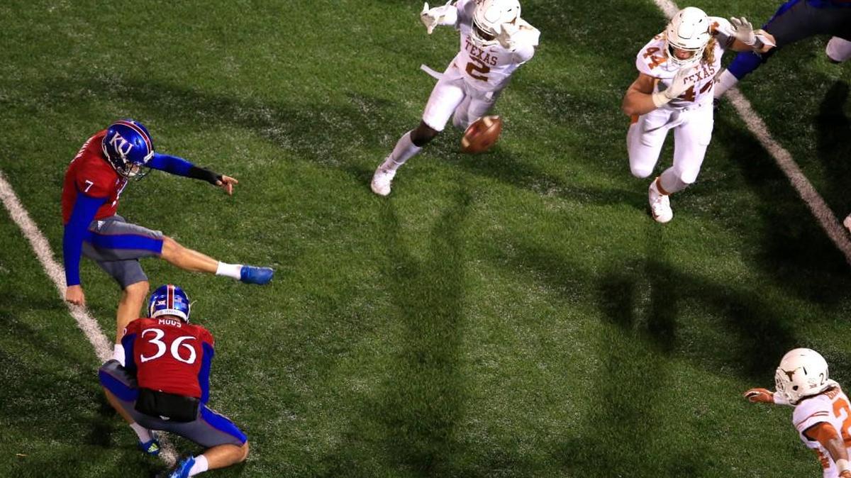 Matthew Wyman kicks the game-winning field goal for Kansas during overtime Saturday in Lawrence.