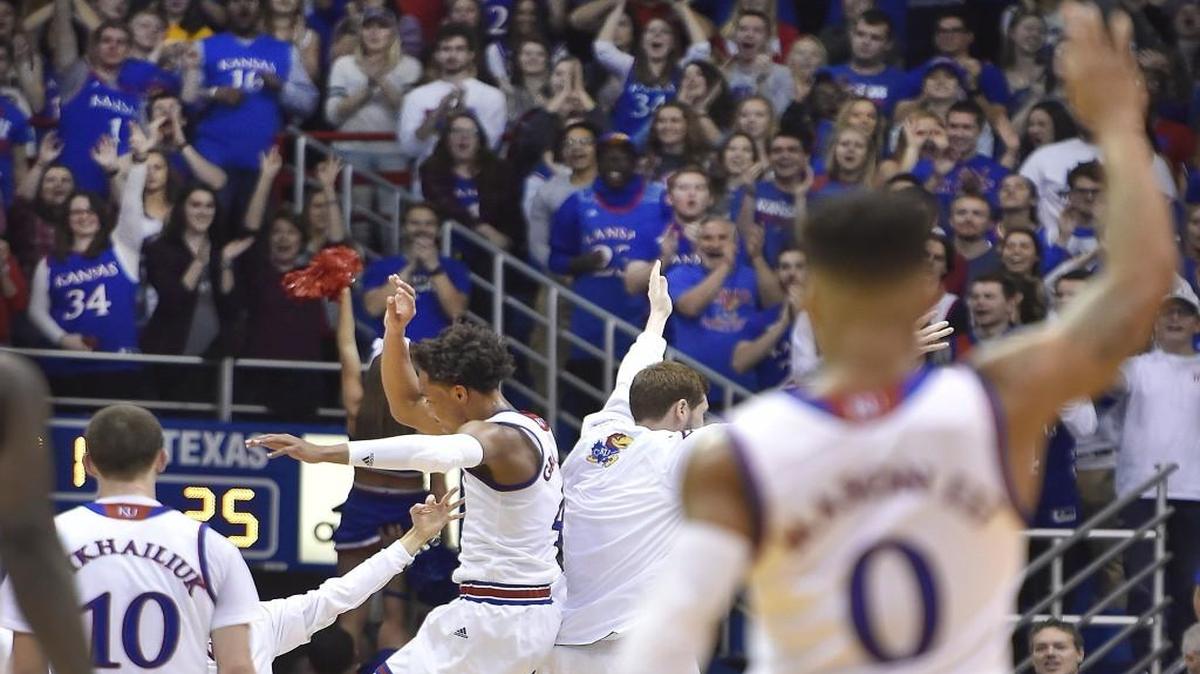 Kansas players celebrate after Texas called a timeout in the first half Saturday.