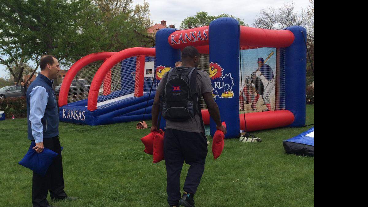 
KU football coach David Beaty, left, played a game of “bags” on Thursday with students.
