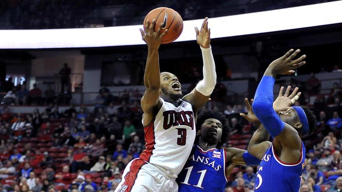 UNLV forward Tyrell Green (3) shoots against KU’s Josh Jackson (11) and Carlton Bragg during the second half of an NCAA college basketball game Thursday, Dec. 22, 2016, in Las Vegas. Kansas won 71-53.