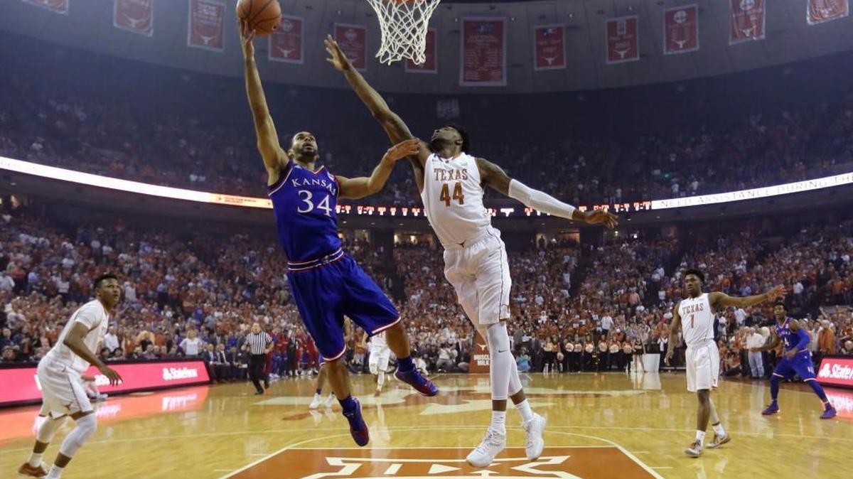 Kansas forward Perry Ellis (34) drives to the basket past Texas center Prince Ibeh (44) during the first half of Monday’s game in Austin, Texas.