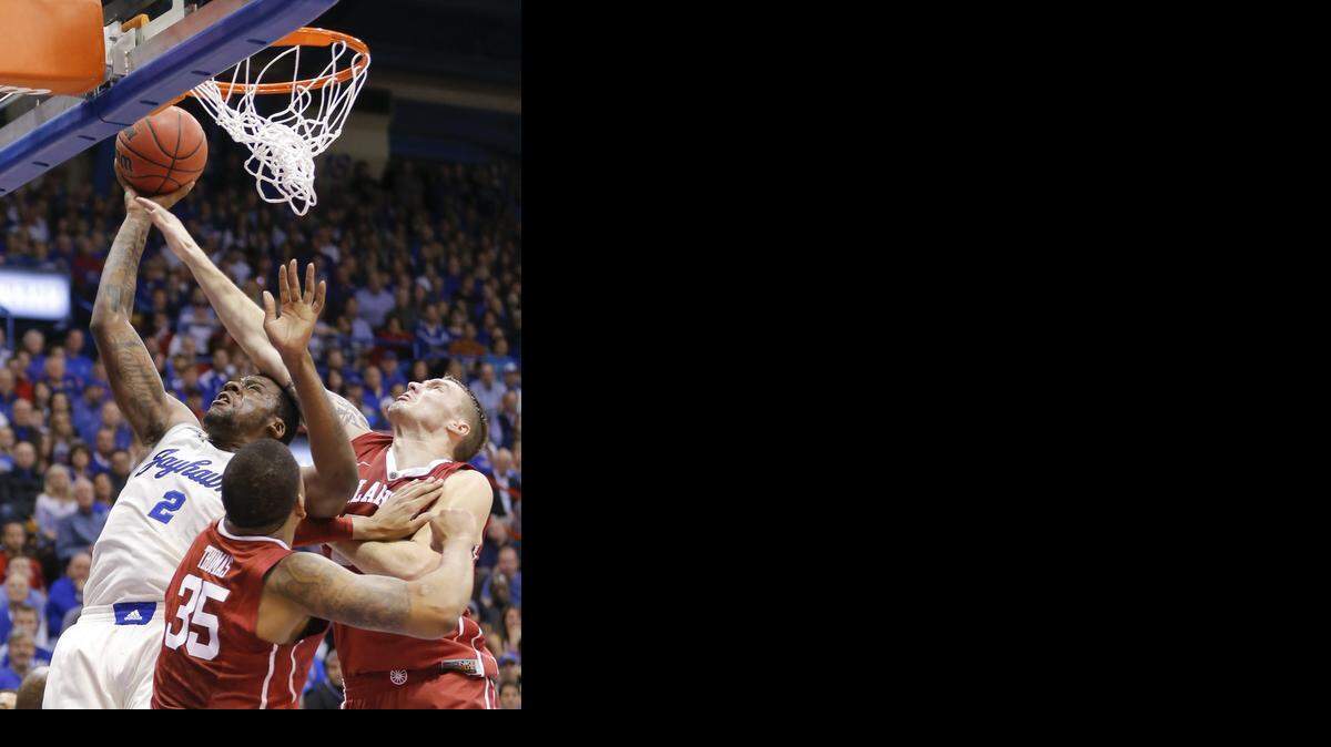 
Kansas forward Cliff Alexander shoots against Oklahoma forward Ryan Spangler, right, and forward TaShawn Thomas during the first half on Monday night at Allen Fieldhouse.
