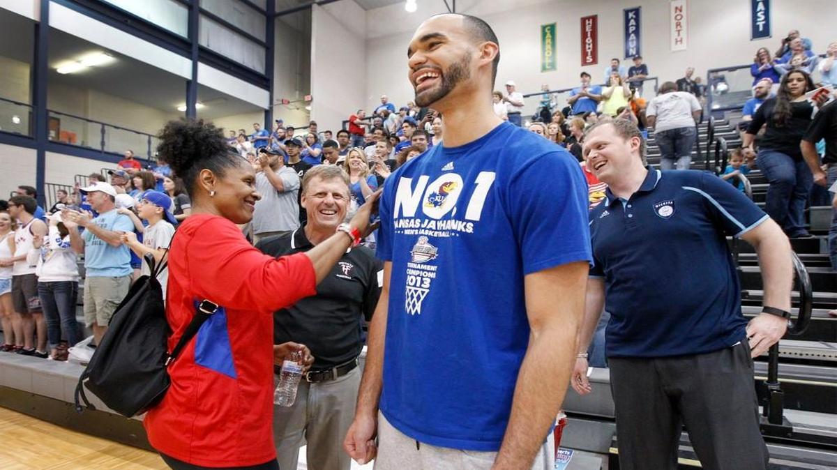 Perry Ellis gets a pat on the back from Lynette Woodard during the KU Barnstorming Tour in May.
