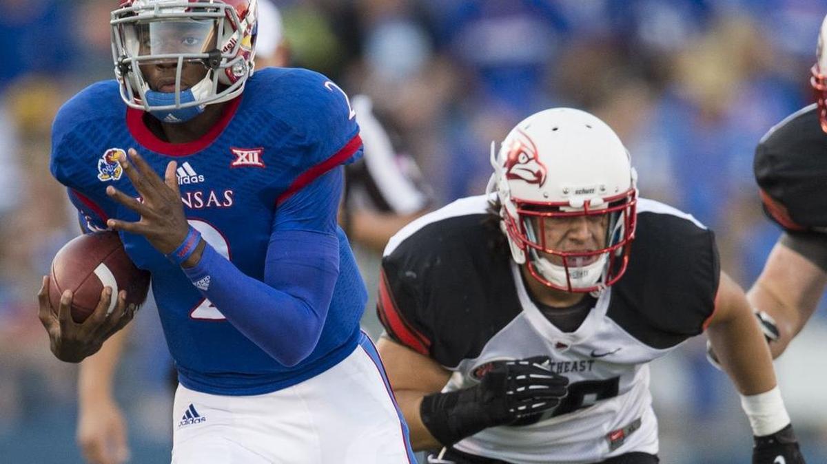 
Kansas Jayhawks quarterback Montell Cozart rushed after shaking free from Southeast Missouri State Redhawks safety Eriq Moore during a game last September.
