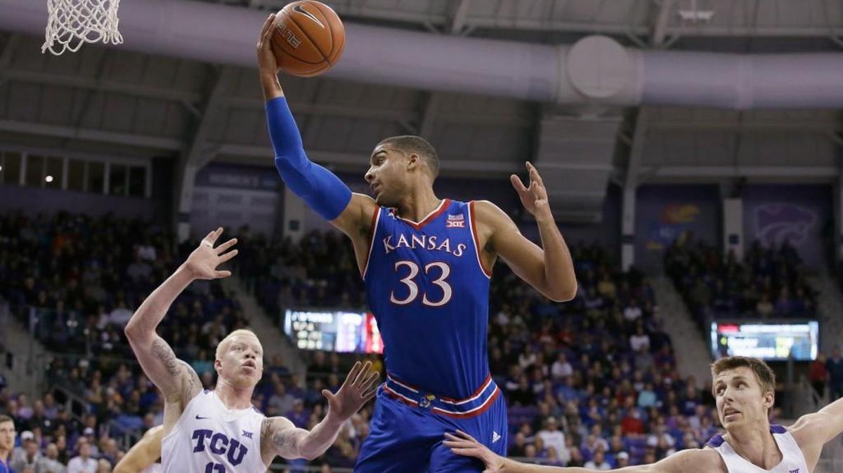 Kansas forward Landen Lucas receives an entry pass against defense from TCU guard Jaylen Fisher (0) and forward Vladimir Brodziansky.