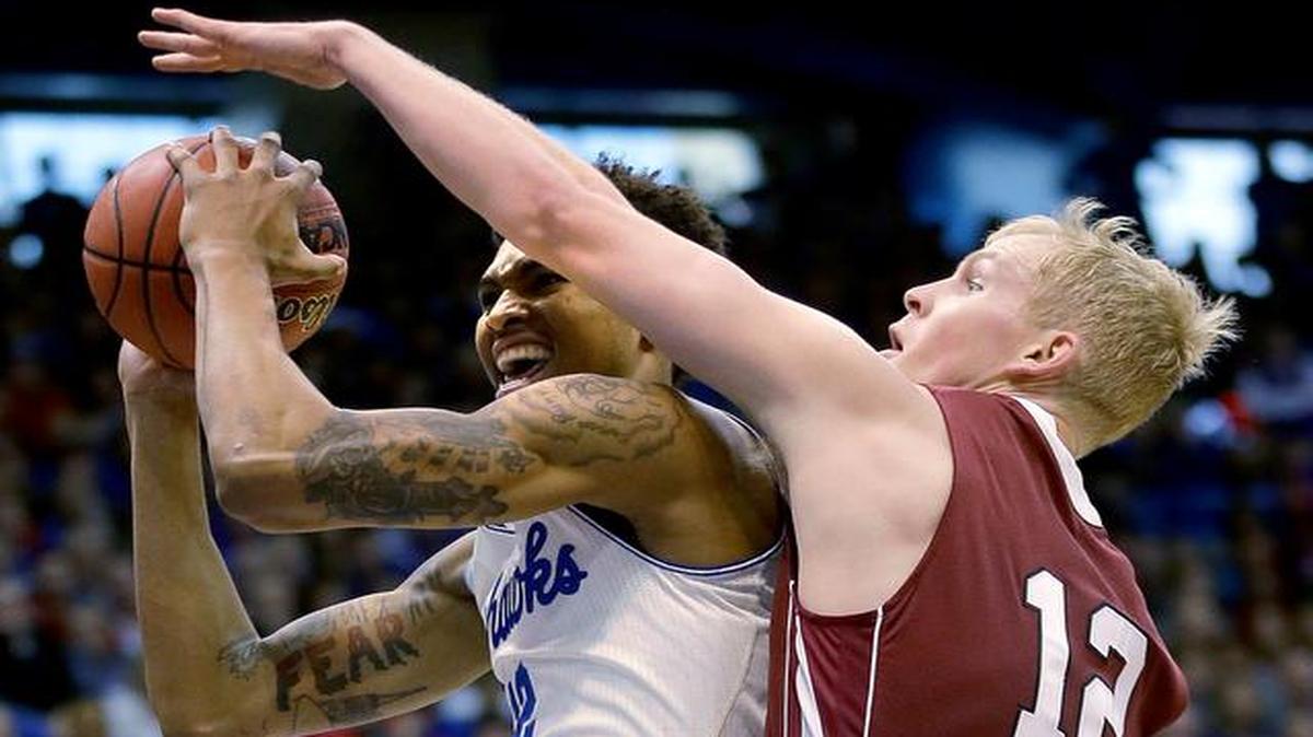 
Kansas' Kelly Oubre Jr., left, shoots under pressure from Lafayette's Seth Hinrichs during the first half Saturday in Lawrence.
