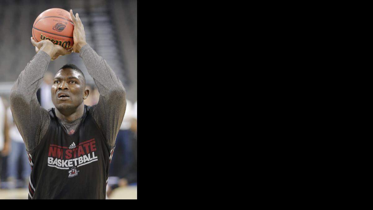 
New Mexico State’s 6-foot-10 Tshilidzi Nephawe shoots during his team’s practice at the CenturyLink Center in Omaha on Thursday.

