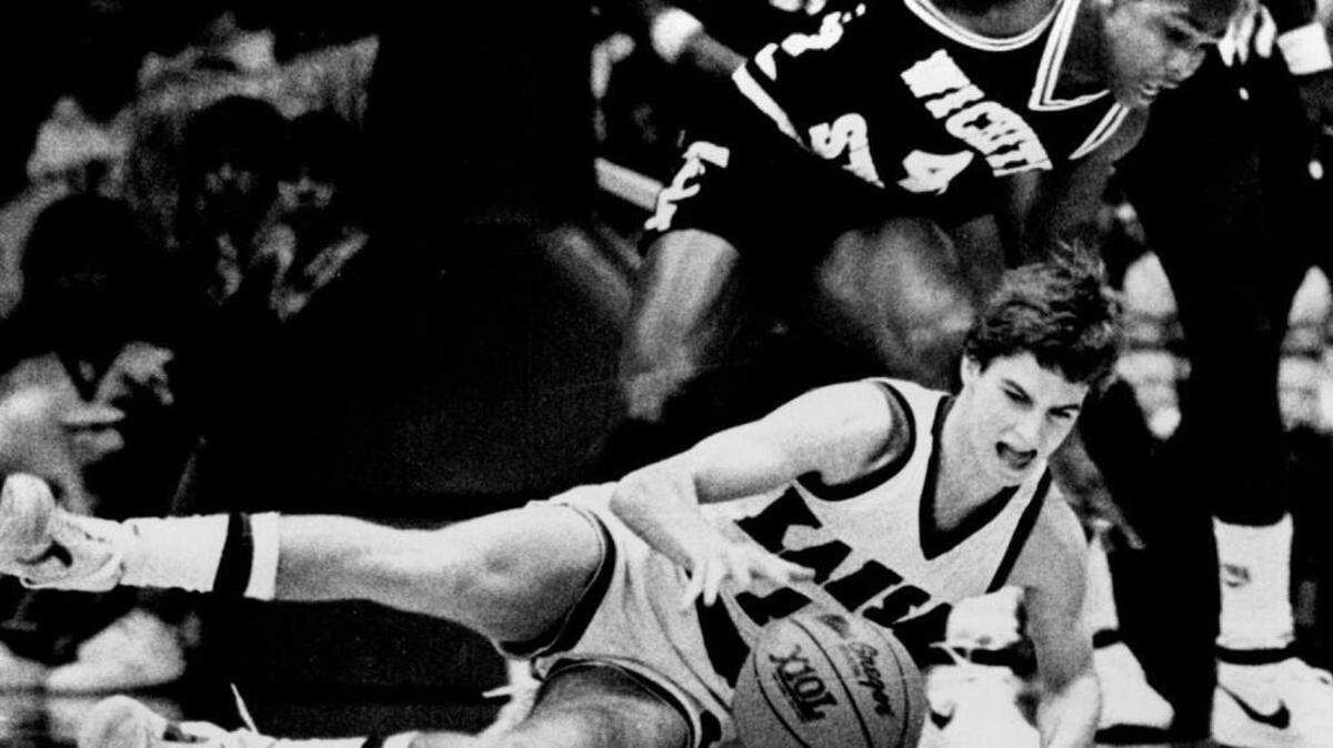 Mark Turgeon dives for a loose ball during his freshman season in 1983-84. He became the first Jayhawk to play in the NCAA Tournament during four seasons.