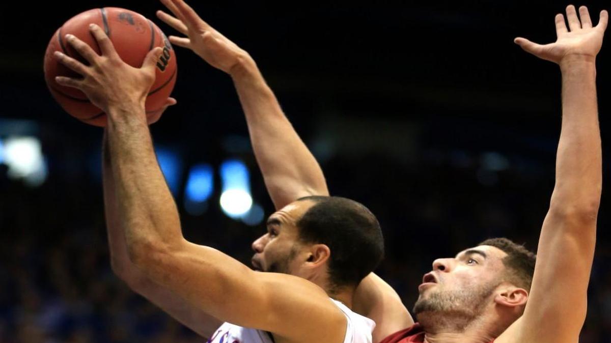 Kansas forward Perry Ellis, left, is fouled by Iowa State’s Georges Niang during the first half Saturday in Lawrence.
