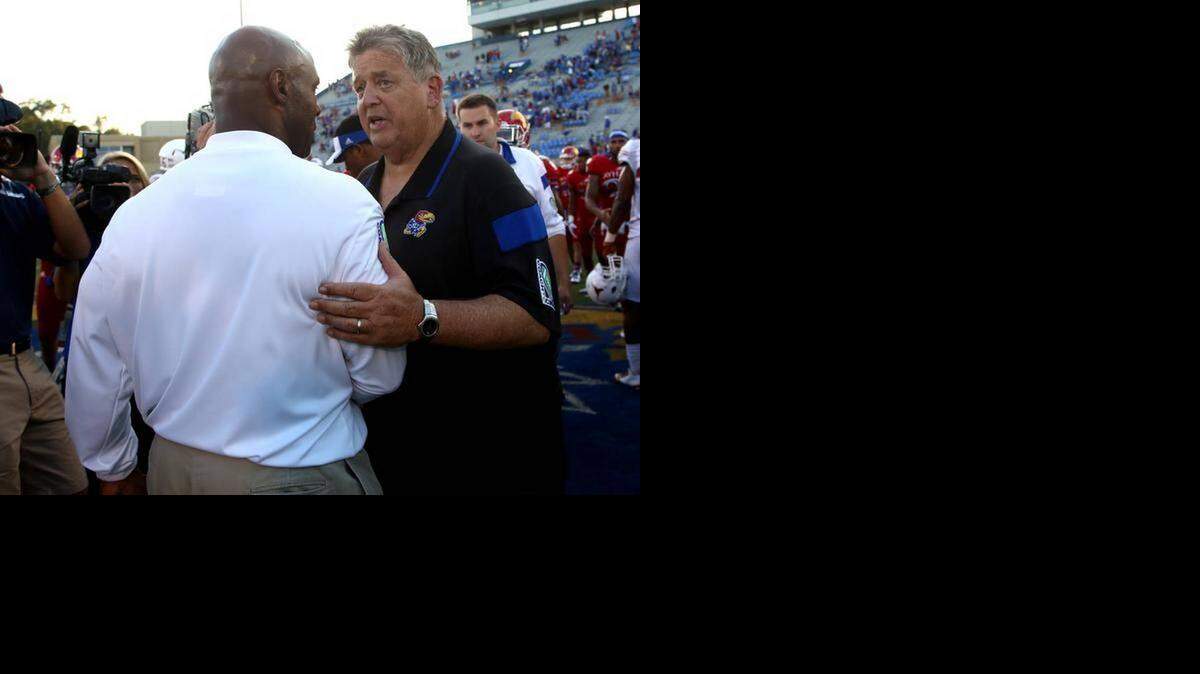 
Texas head coach Charlie Strong, front, and Kansas head coach Charlie Weis meet on the field after an NCAA football game Saturday, Sept. 27, 2014, in Lawrence, Kan. Texas won 23-0.
