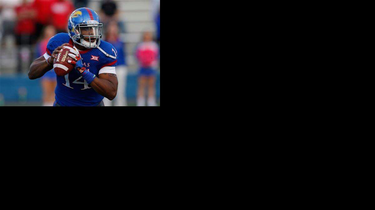 
Kansas quarterback Michael Cummings surveys the field on a second-half pass play against Oklahoma State in Lawrence last Saturday. 

