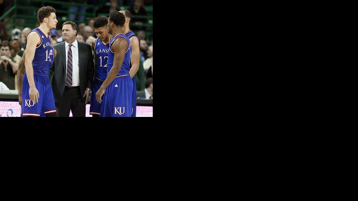 
Kansas head coach Bill Self, center, looks down court during a team huddle as officials confer on a call in the second half of an NCAA college basketball game against Baylor, Wednesday, Jan. 7, 2015, in Waco, Texas. Kansas won 56-55. (AP Photo/Tony Gutierrez)
